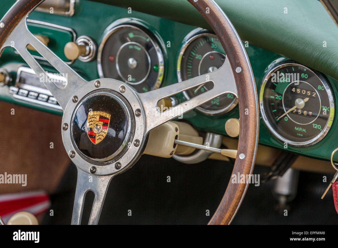 An image of a Porsche 356 interior steering wheel with green leather dashboard trim London UK Stock Photo