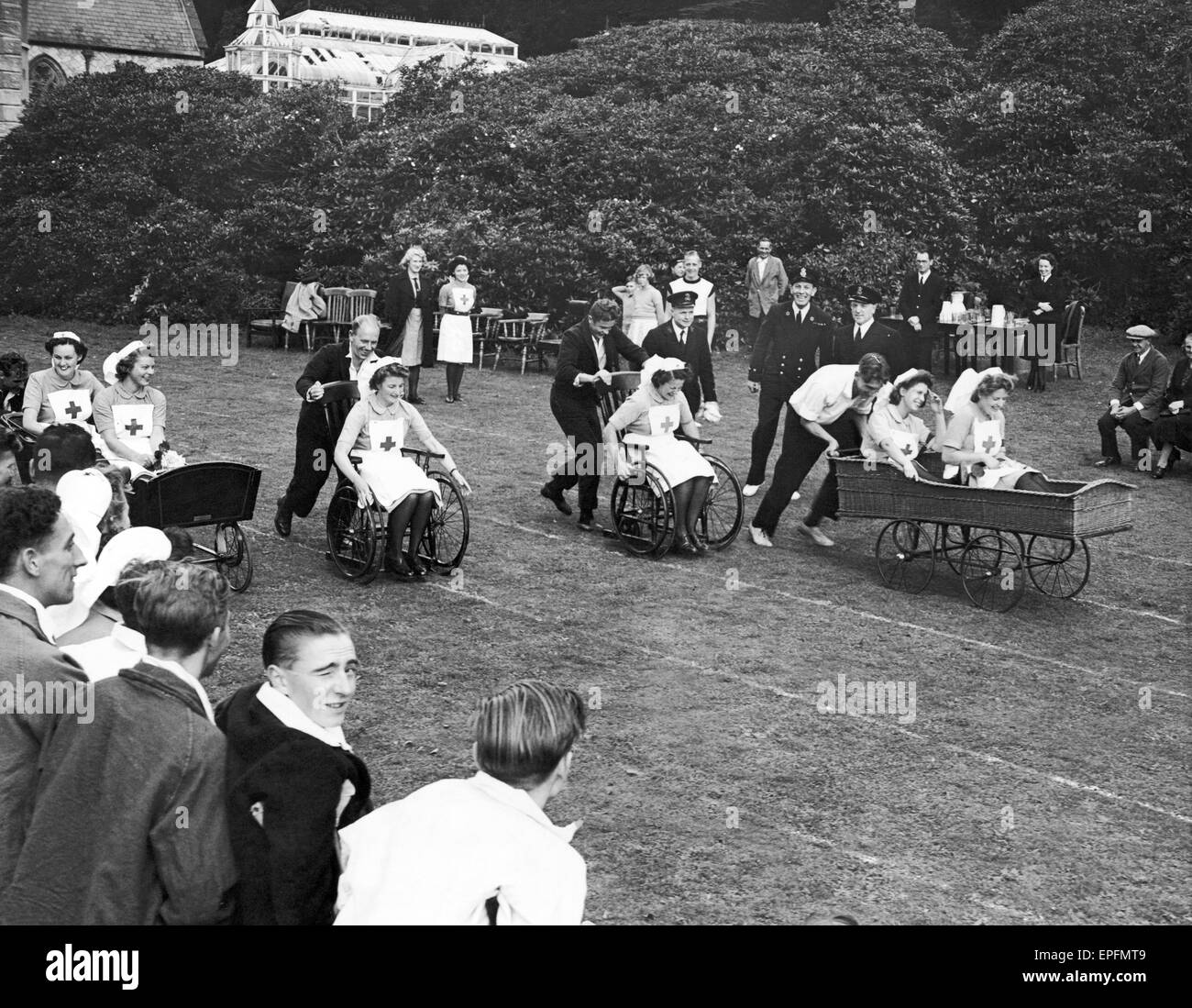 Sports Day for Patients and Staff from Maristow Royal Naval Auxiliary Hospital near Yelverton, Devon, September 1944.  Invalid Chair Race held on the lawn of the home of the Earl of Roborough. The nurses decided to join in the fun & changed places, while Stock Photo