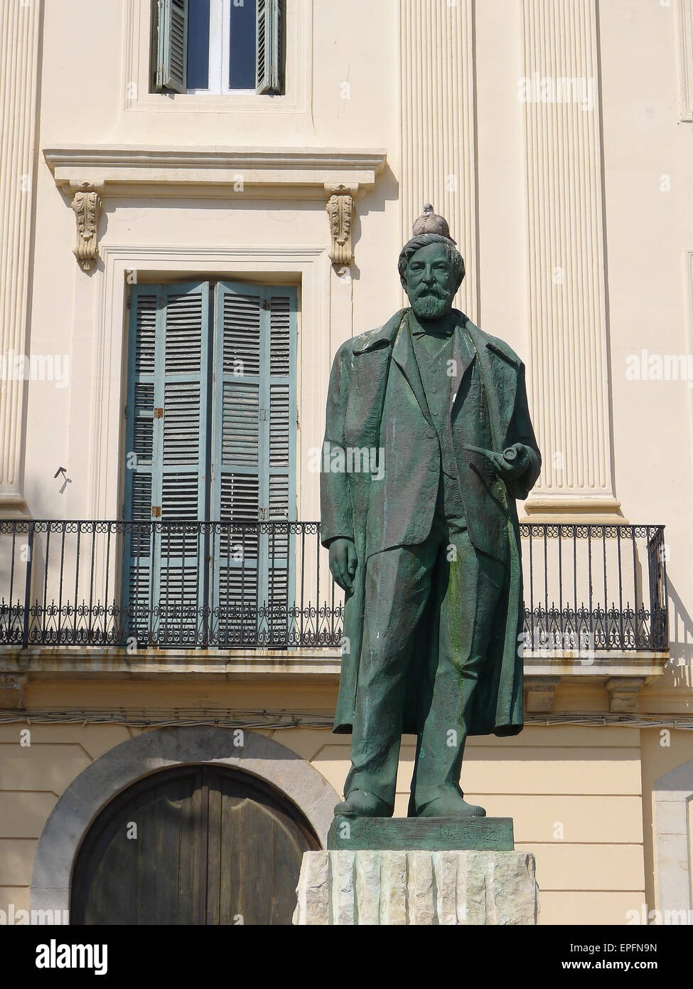 Statue of Catalan artist Santiago Rusiñol with pigeon on head in town of Sitges, Catalonia, Spain Stock Photo