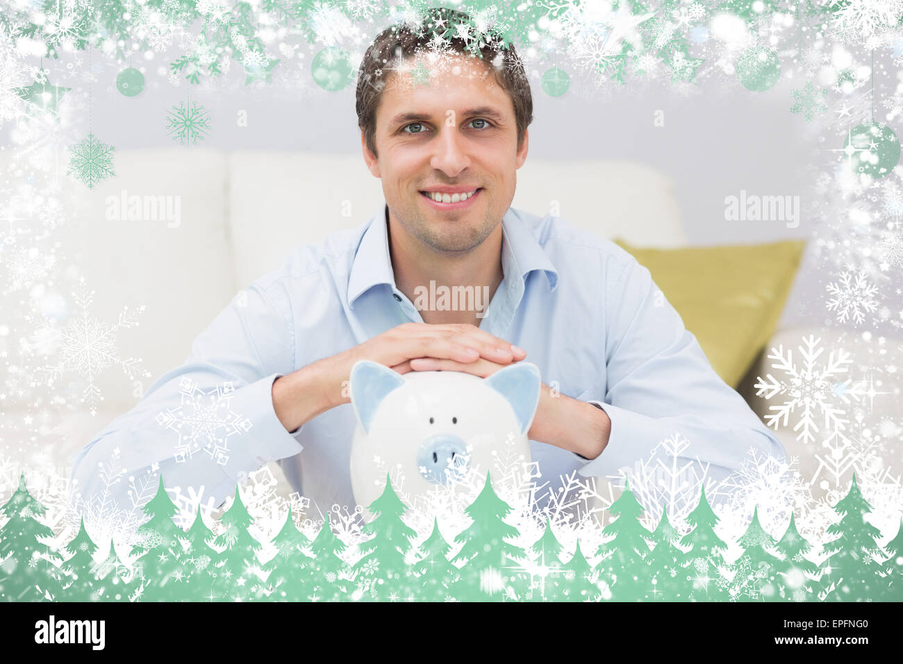 Handsome casual man with piggy bank in living room Stock Photo - Alamy
