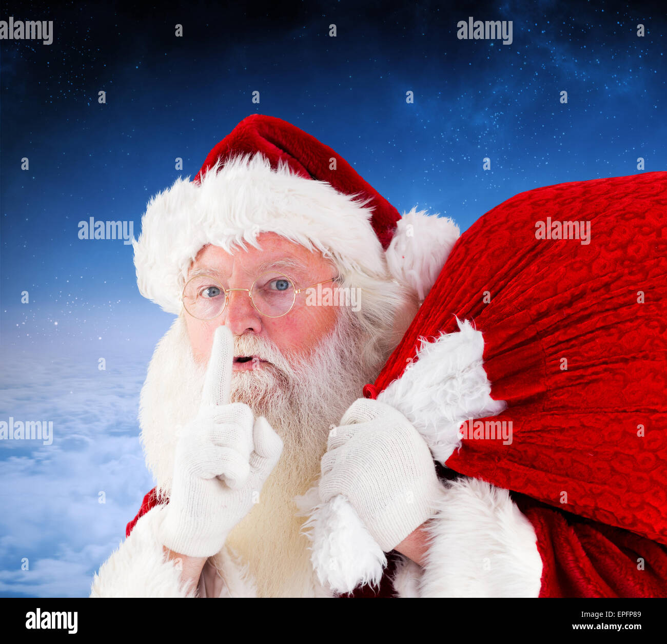 Composite image of santa claus carrying sack Stock Photo - Alamy