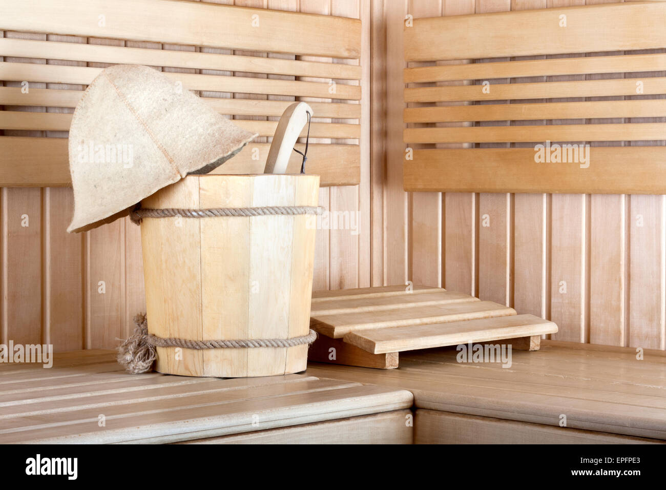 Traditional wooden sauna for relaxation with bucket of water Stock Photo