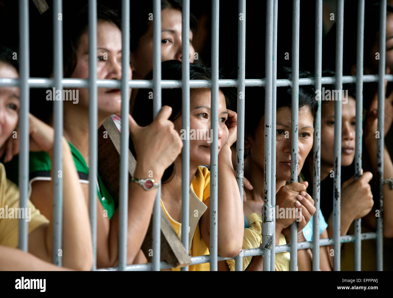 Convicted women behind bars in a communal cell in the Angeles District Jail, The Phillipines Stock Photo