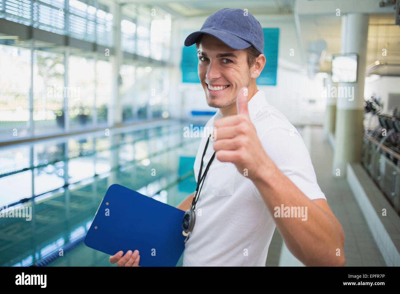 Swimming coach standing pool smiling hi 