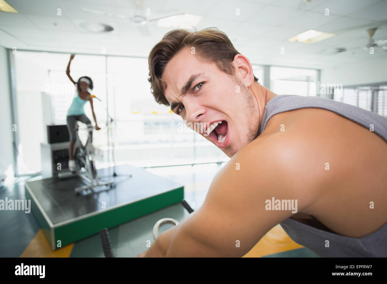 Handsome man smiling at camera in spin class Stock Photo - Alamy