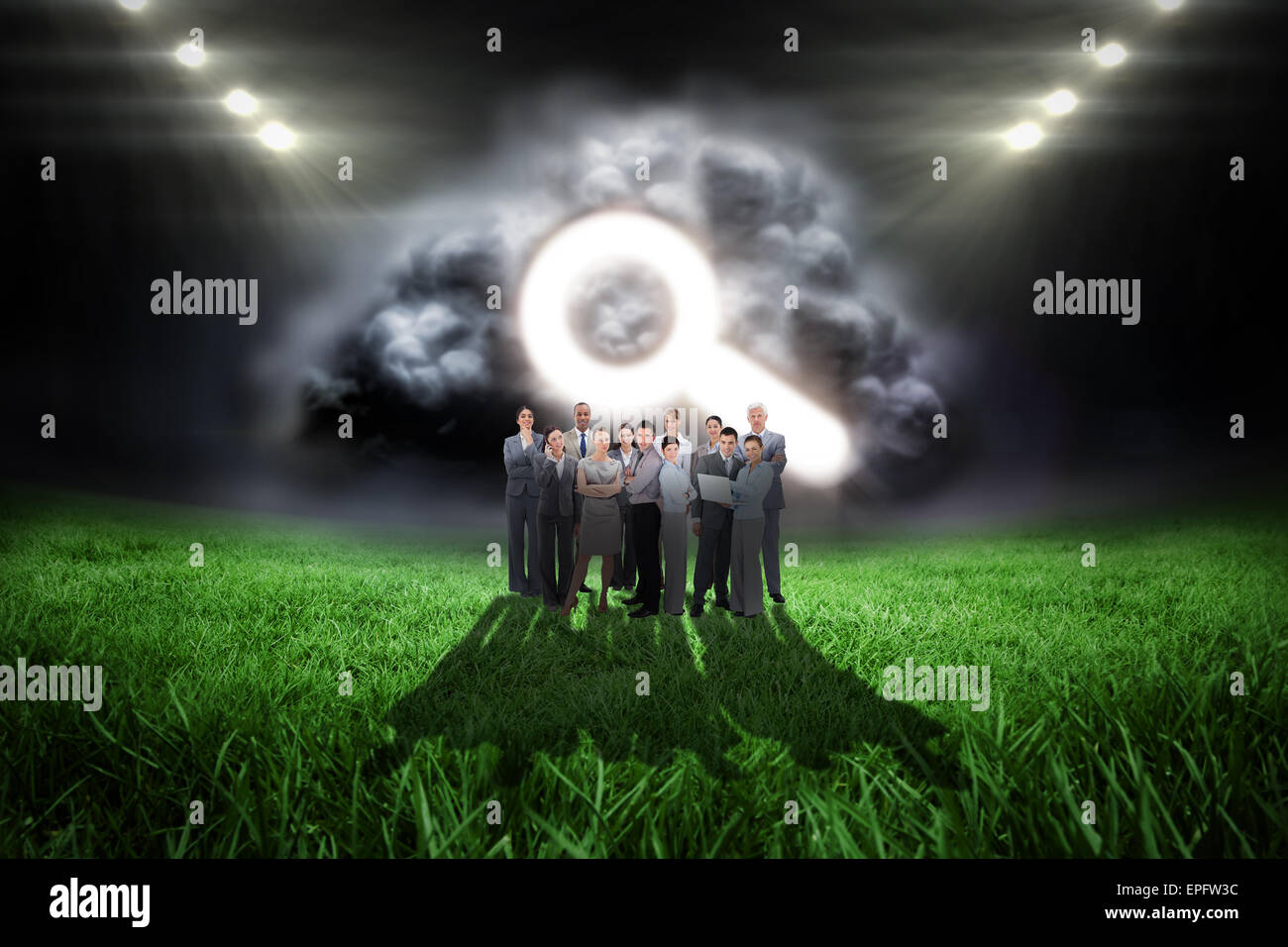 Composite image of business team looking at camera Stock Photo - Alamy
