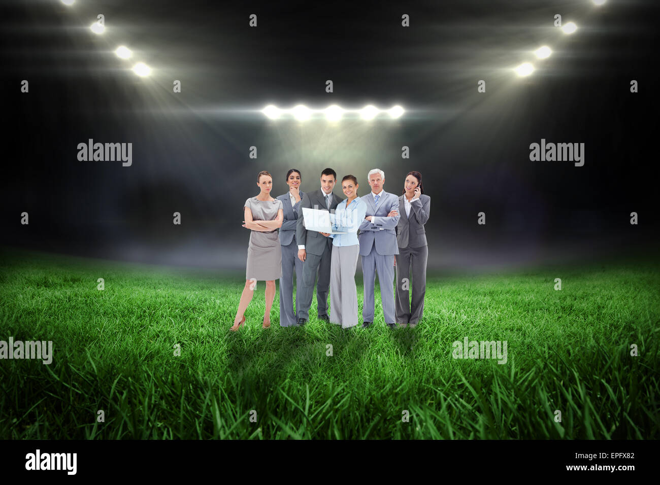 Composite image of business team looking at camera Stock Photo - Alamy