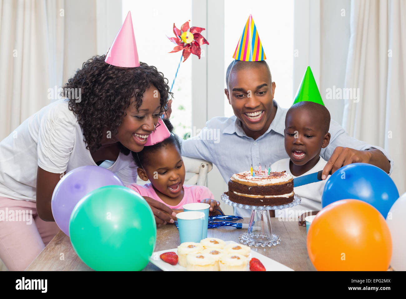 Happy family celebrating a birthday together at table Stock Photo
