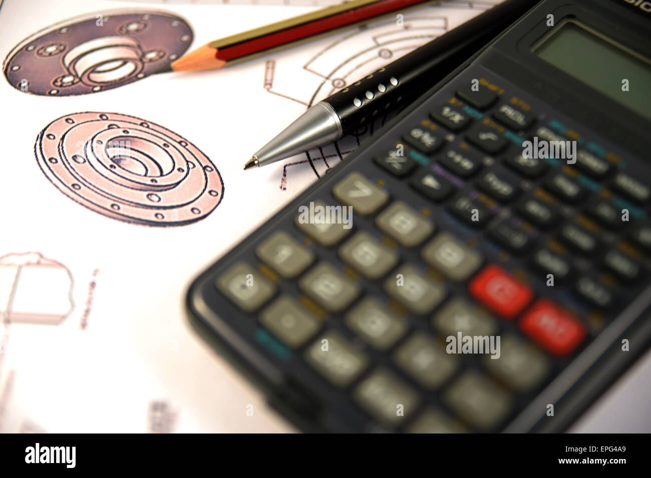 Scientific calculator, Pen and Pencil over the Engineering Drawing Map Stock Photo