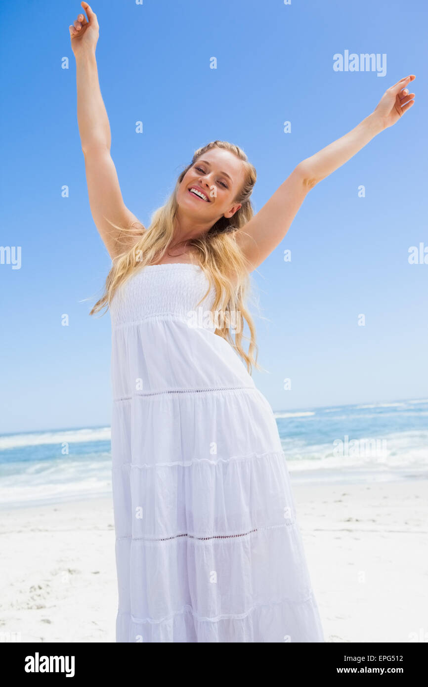 Pretty carefree blonde smiling at camera on the beach Stock Photo - Alamy