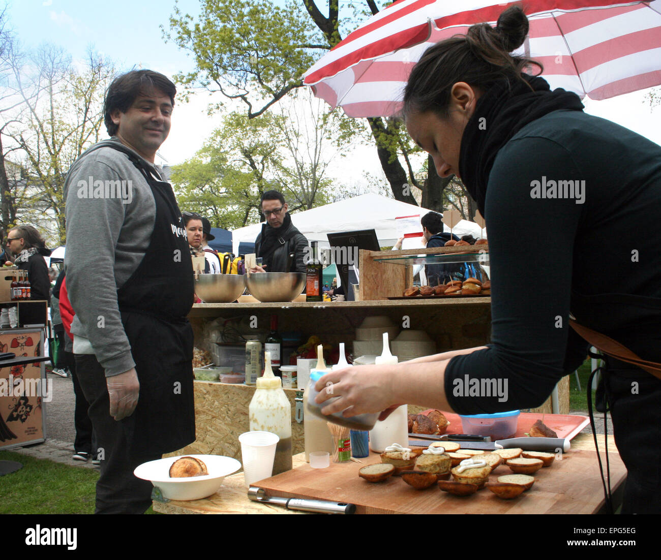 Helsinki, Finland. 16th May, 2015. Antonio Fernandez and his wife Laura Bravo from Spain offer mini blinis at their food stall during Restaurant Day in Helsinki, Finland, 16 May 2015. Photo: Julia Waeschenbach/dpa/Alamy Live News Stock Photo