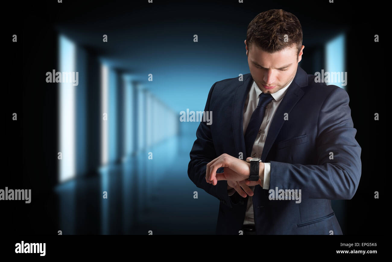 Composite image of handsome businessman checking the time Stock Photo ...