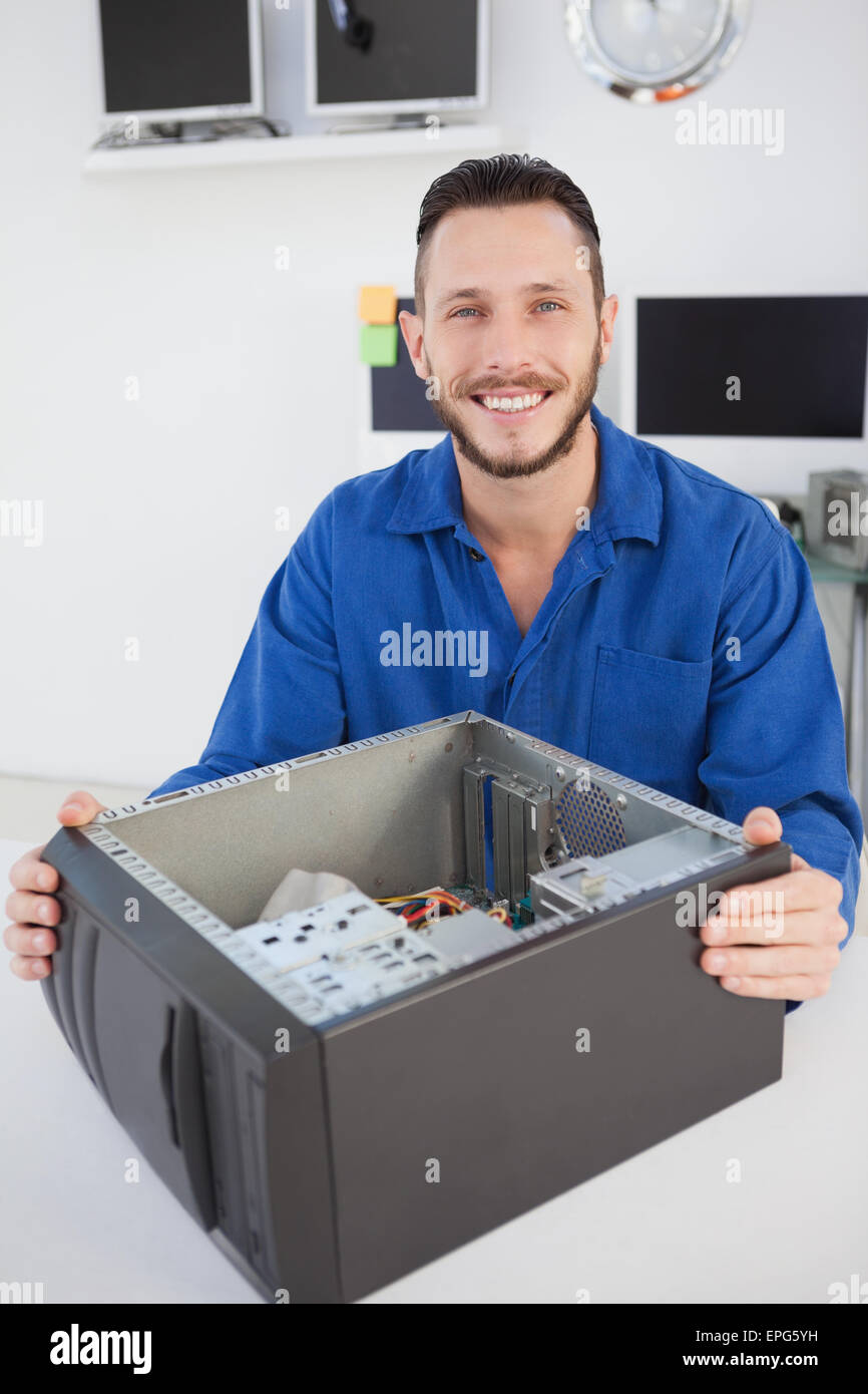 Computer engineer sitting with open computer smiling at camera Stock ...