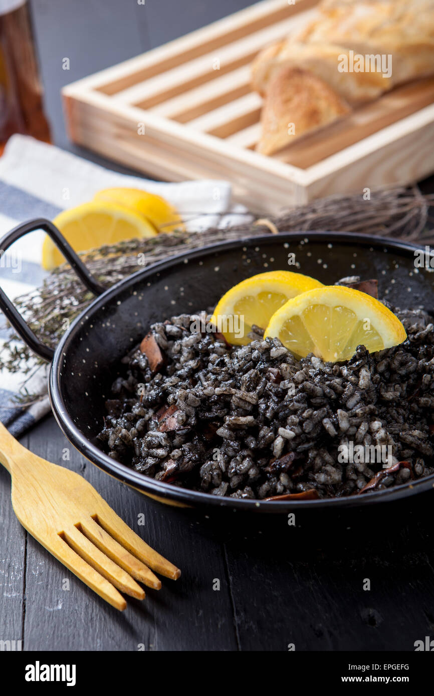 seafood risotto with black calamari ink on pot Stock Photo