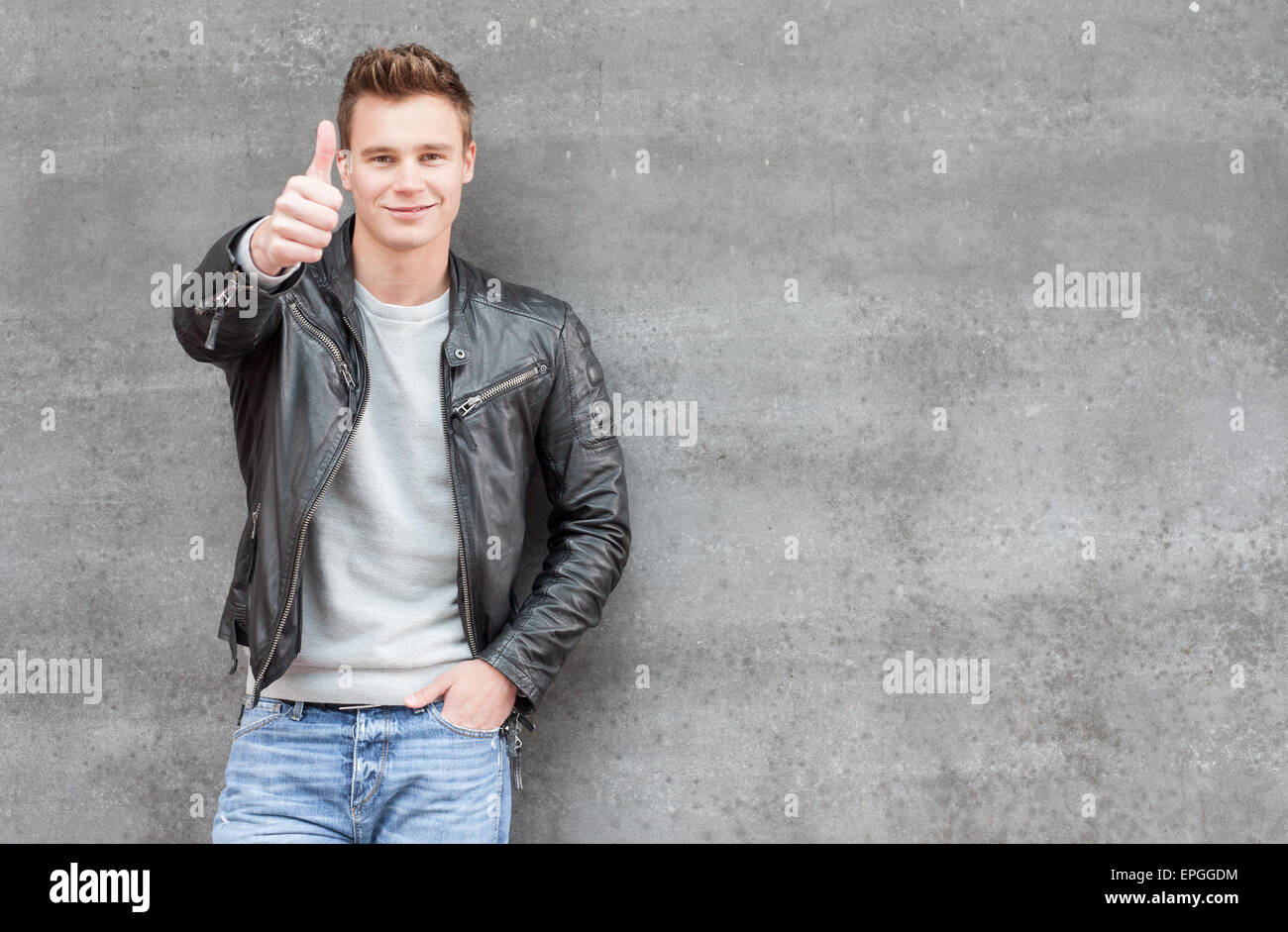 Casual young guy showing thumbs up Stock Photo