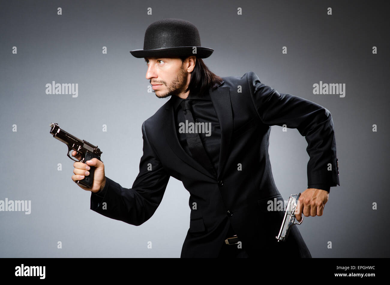 Man wearing vintage hat with gun Stock Photo Alamy