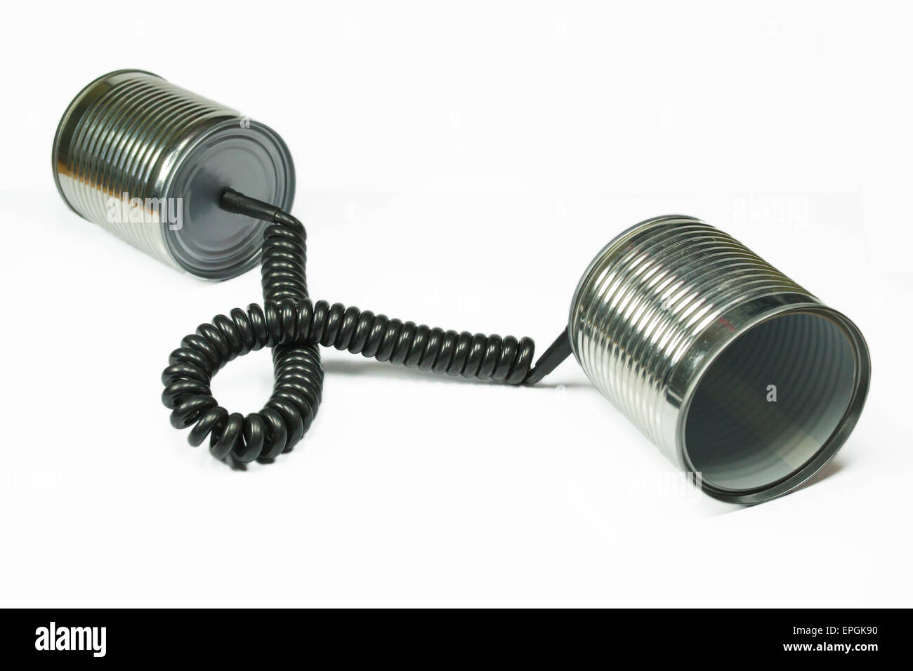 Two aluminum cans connected through a telephone cord , concept for communication Stock Photo