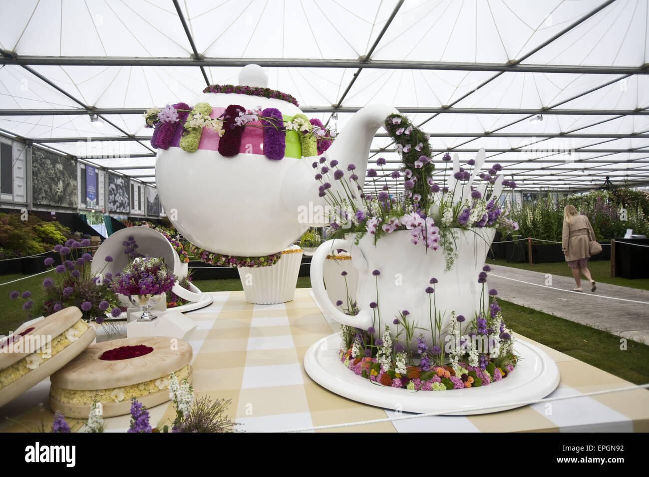 London, UK. 18th May, 2015. Interflora display features larger then life tea pot and a tea cup complete with muffins and buiscits. The Chelsea Flower Show organised by Royal Horticultural Society (RHS) in the grounds of the Royal Hospital Chelsea every May, is the most famous flower show in the United Kingdom, perhaps in the world. It attracts exhibitors and visitors from around the world, London, UK. Credit:  Veronika Lukasova/ZUMA Wire/Alamy Live News Stock Photo