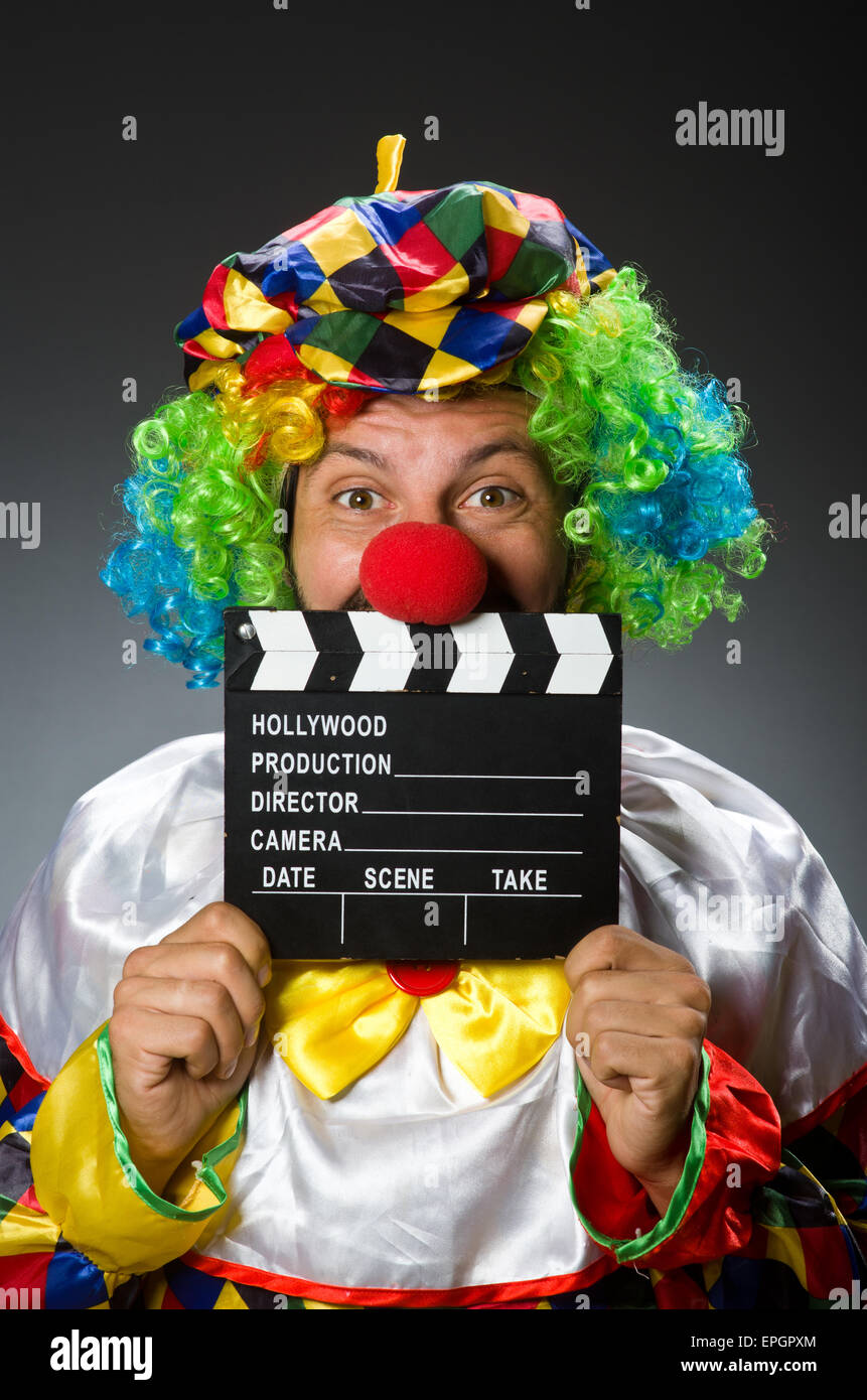 Clown with movie clapper board Stock Photo