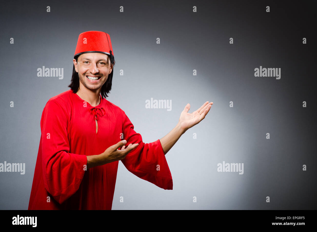 Man in red dress wearing fez hat Stock Photo Alamy