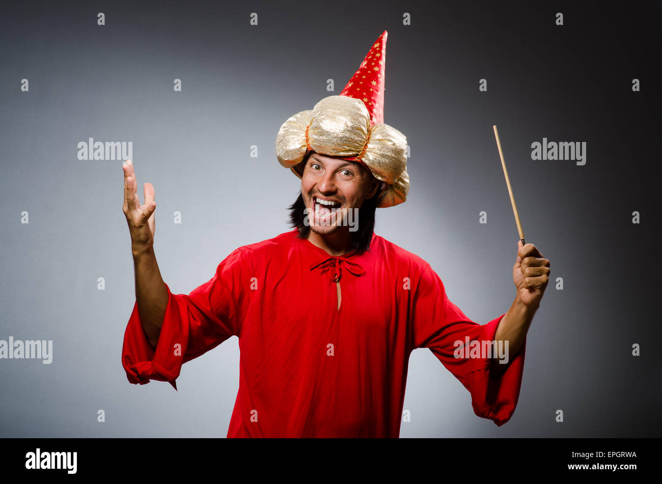 Funny wizard wearing red dress Stock Photo - Alamy