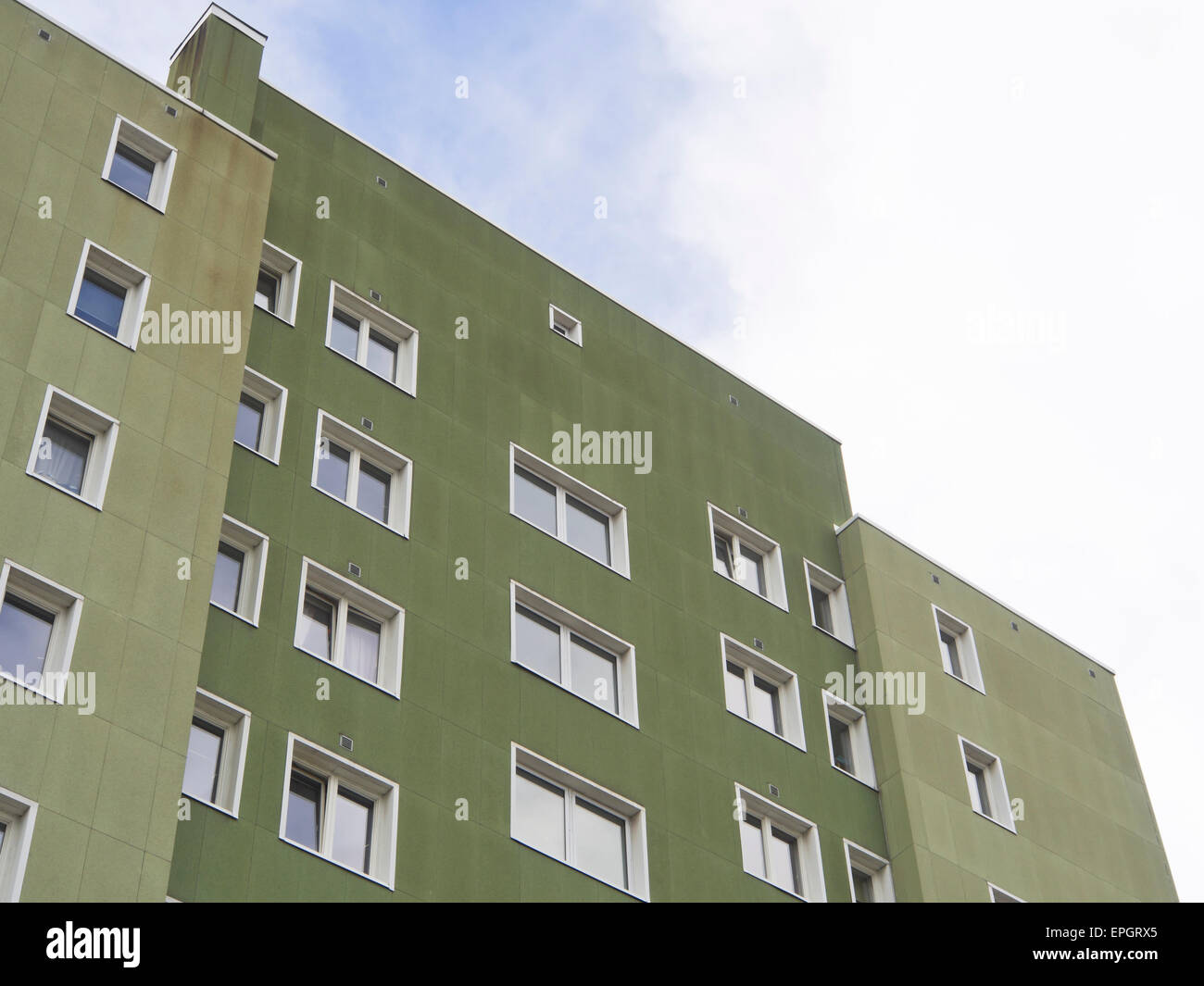 Apartment block rising against the sky, green concrete highrise with white window frames, Oslo Norway Stock Photo