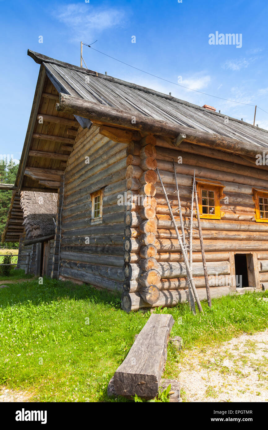 Russian rural wooden architecture example, old bench stands near house Stock Photo