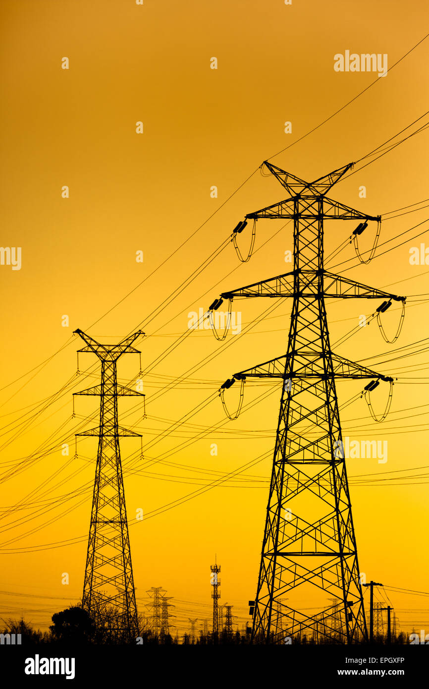 High voltage towers at sunset Stock Photo