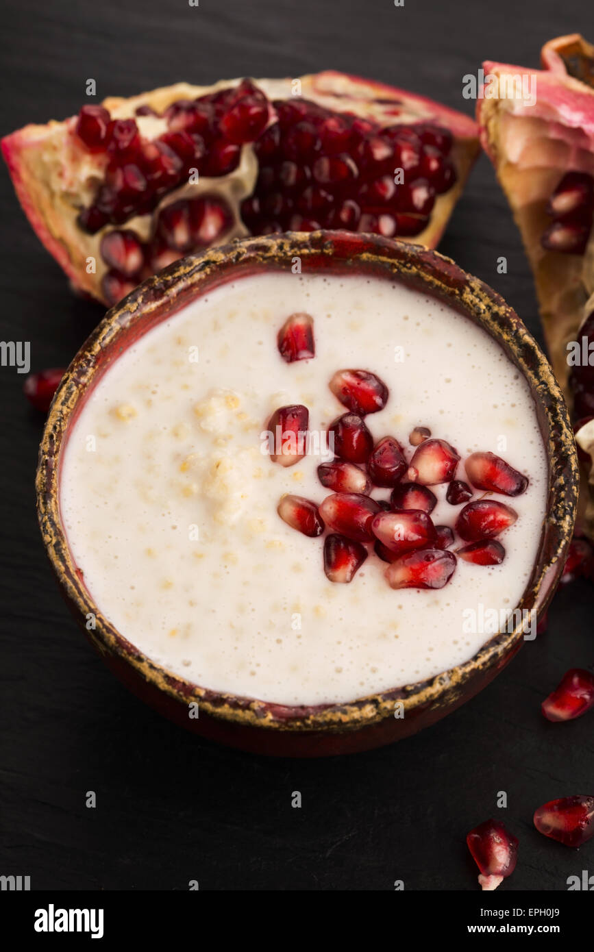 Dish of banana millet breakfast pudding with pomegranate Stock Photo