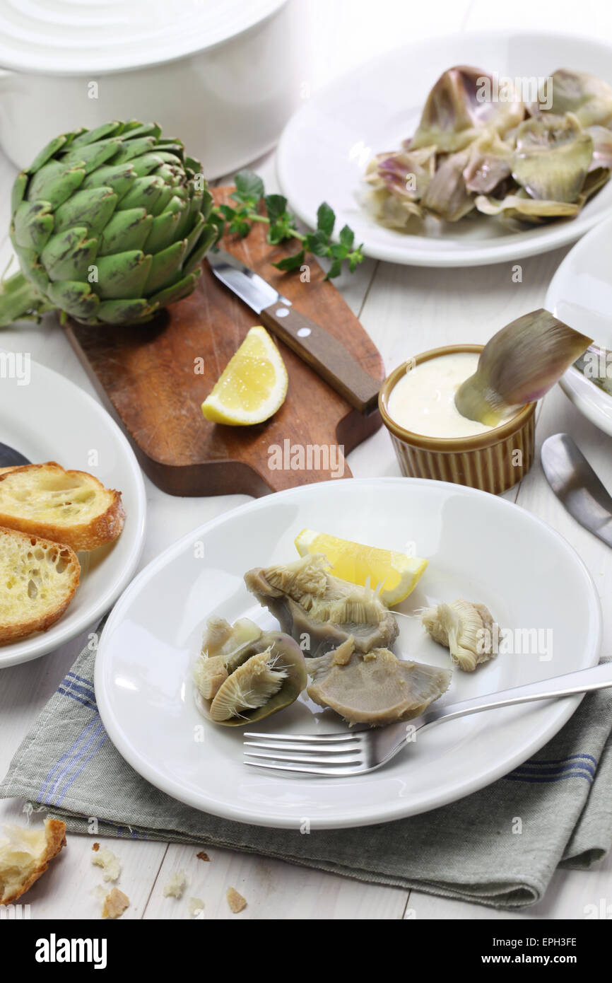 eating boiled artichoke, italian cuisine Stock Photo Alamy