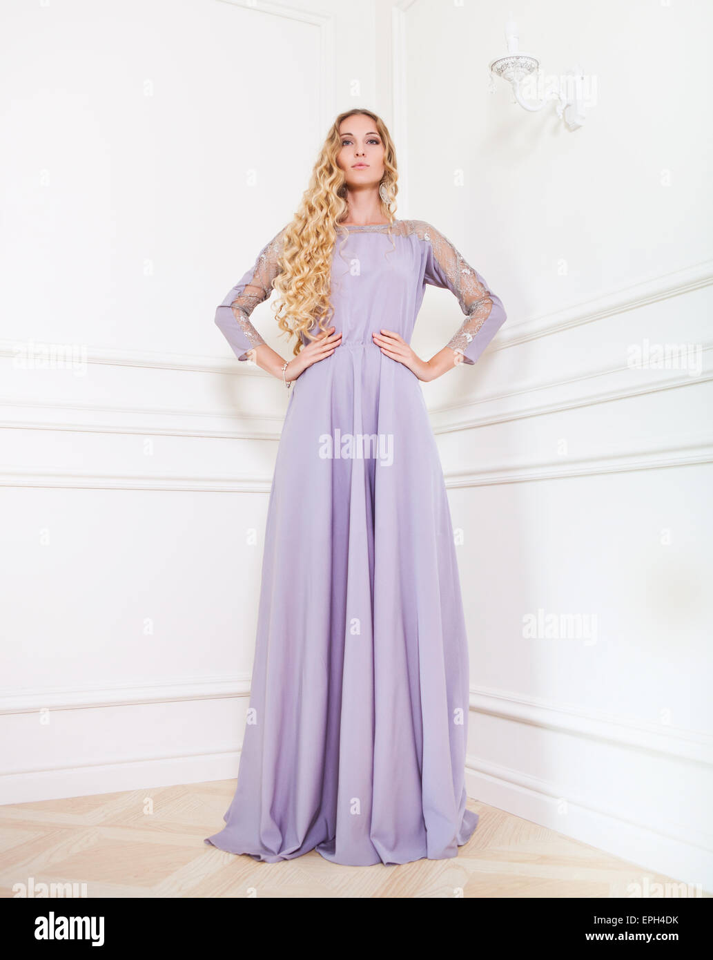 Portrait of the beautiful blond woman in long dress Stock Photo - Alamy