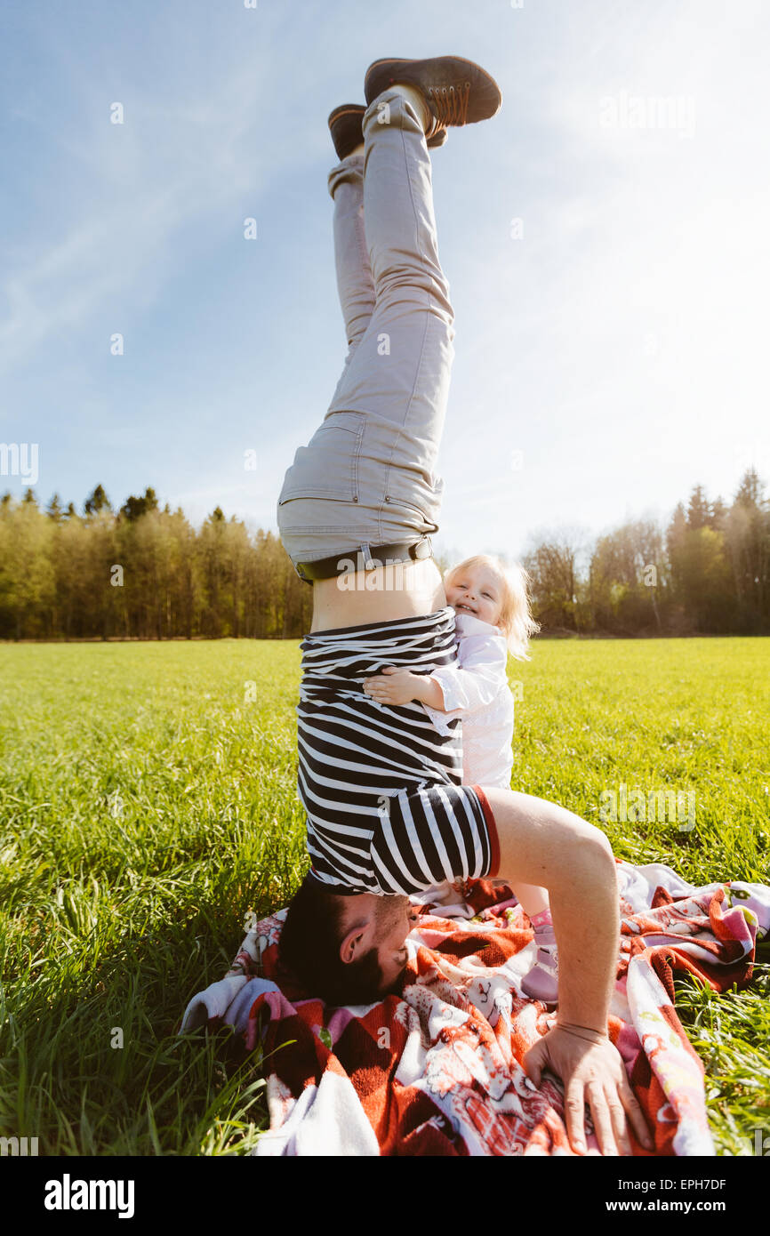 Dad standing on his head Stock Photo Alamy
