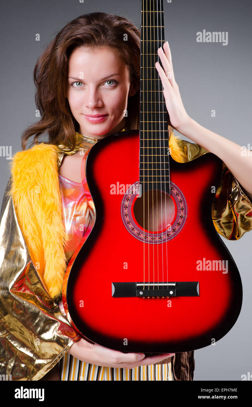 Guitar player with red instrument Stock Photo - Alamy