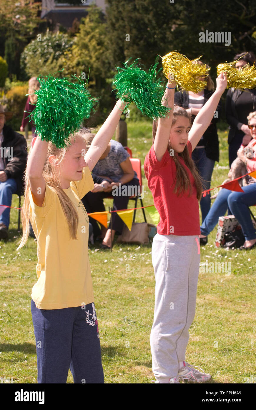 Young cheerleaders performing at a May Fair, Oakhanger, Hampshire, UK. Stock Photo