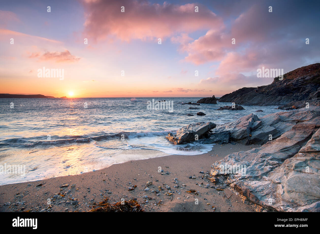 Sunset from Little Fistral beach, a small sheltered cove beneath the Towan headland at Newquay on the Cornish coast Stock Photo