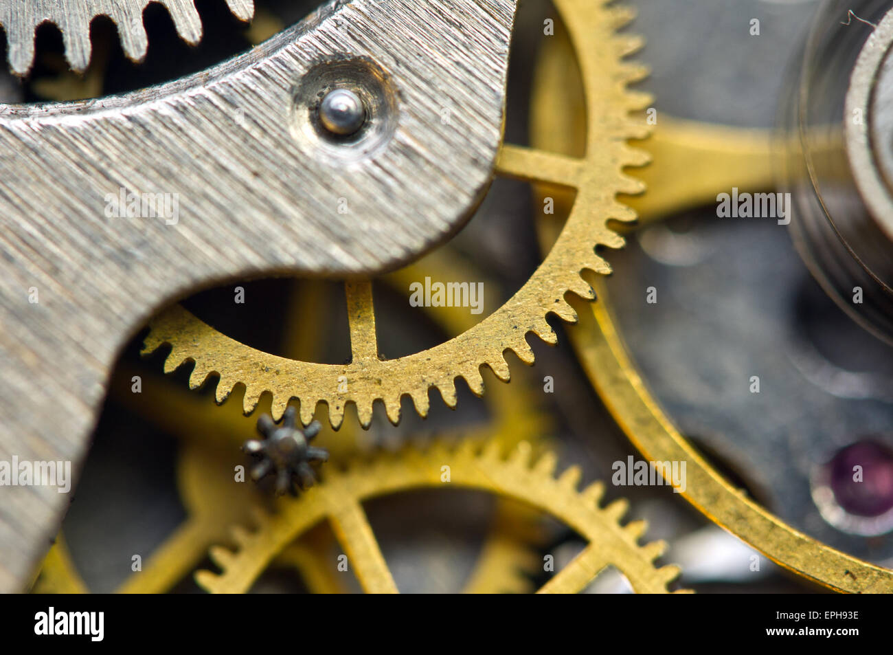 Background with golden metal cogwheels inside clockwork. Conceptual photo for your successful business design. Macro. Stock Photo