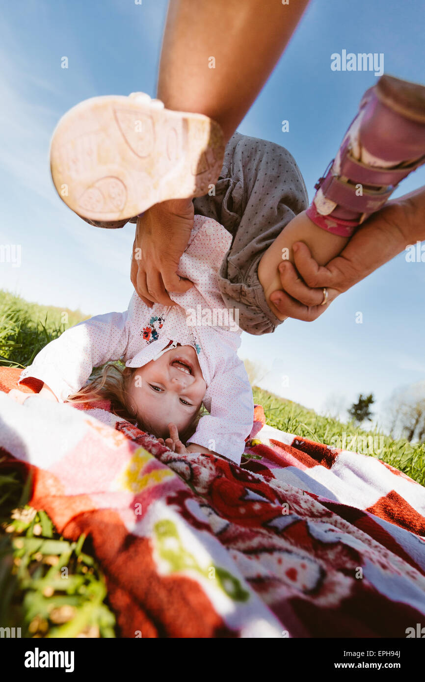 Little girl standing on his head Stock Photo - Alamy