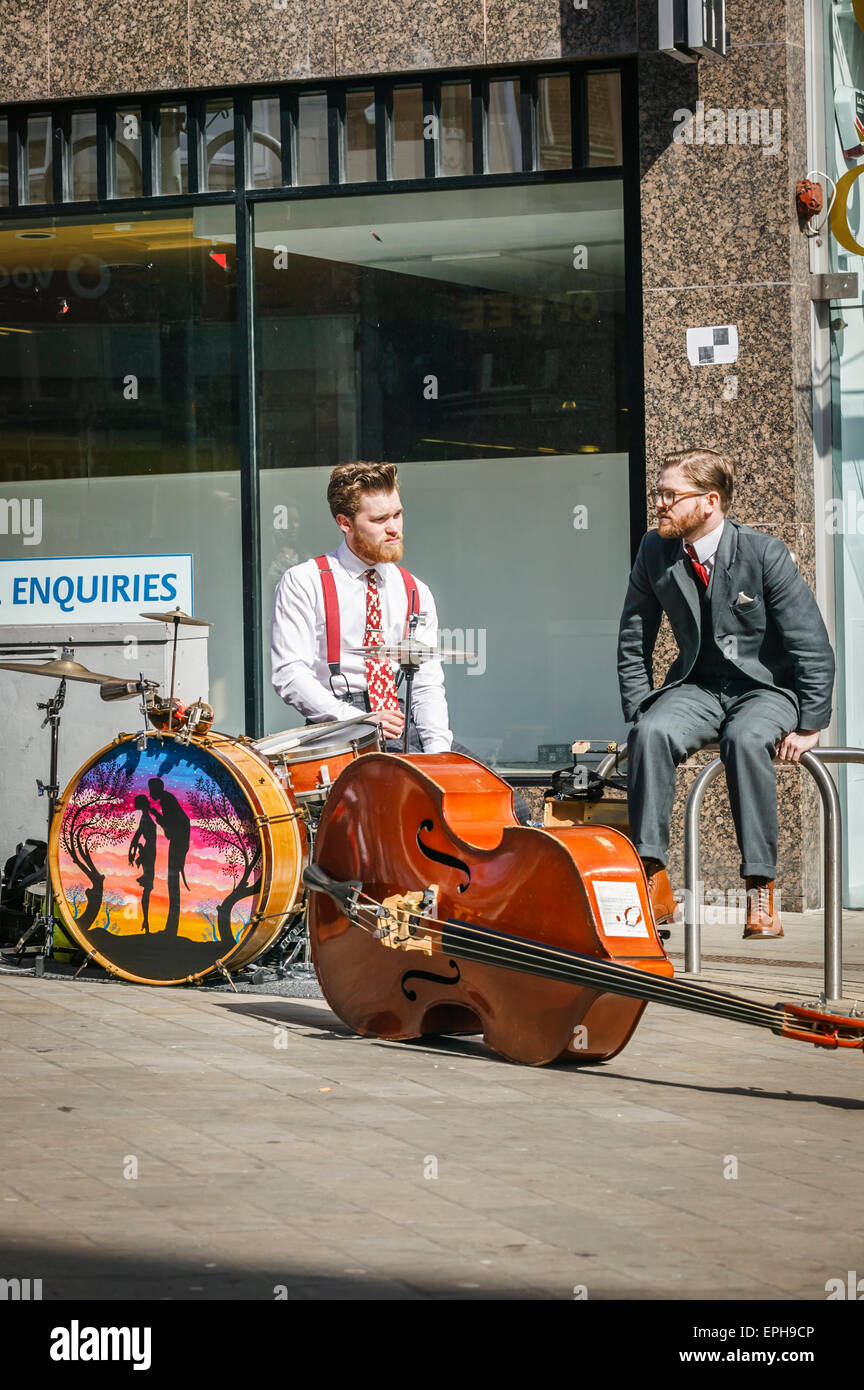Briggate Busy Shopping District, Leeds West Yorkshire,Two Young Street Musicians Taking a Break, Stock Photo