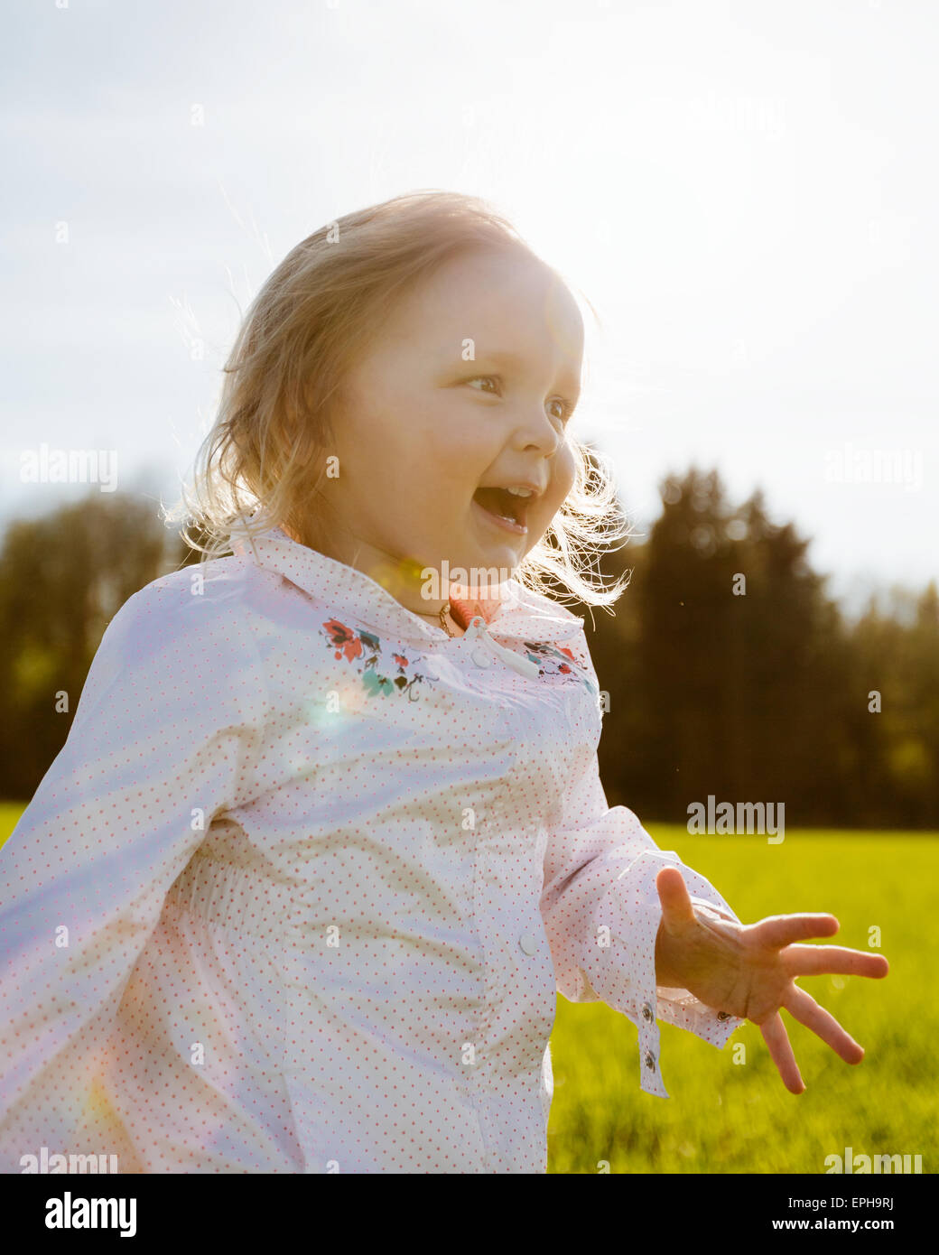 Little girl walks in the park Stock Photo - Alamy
