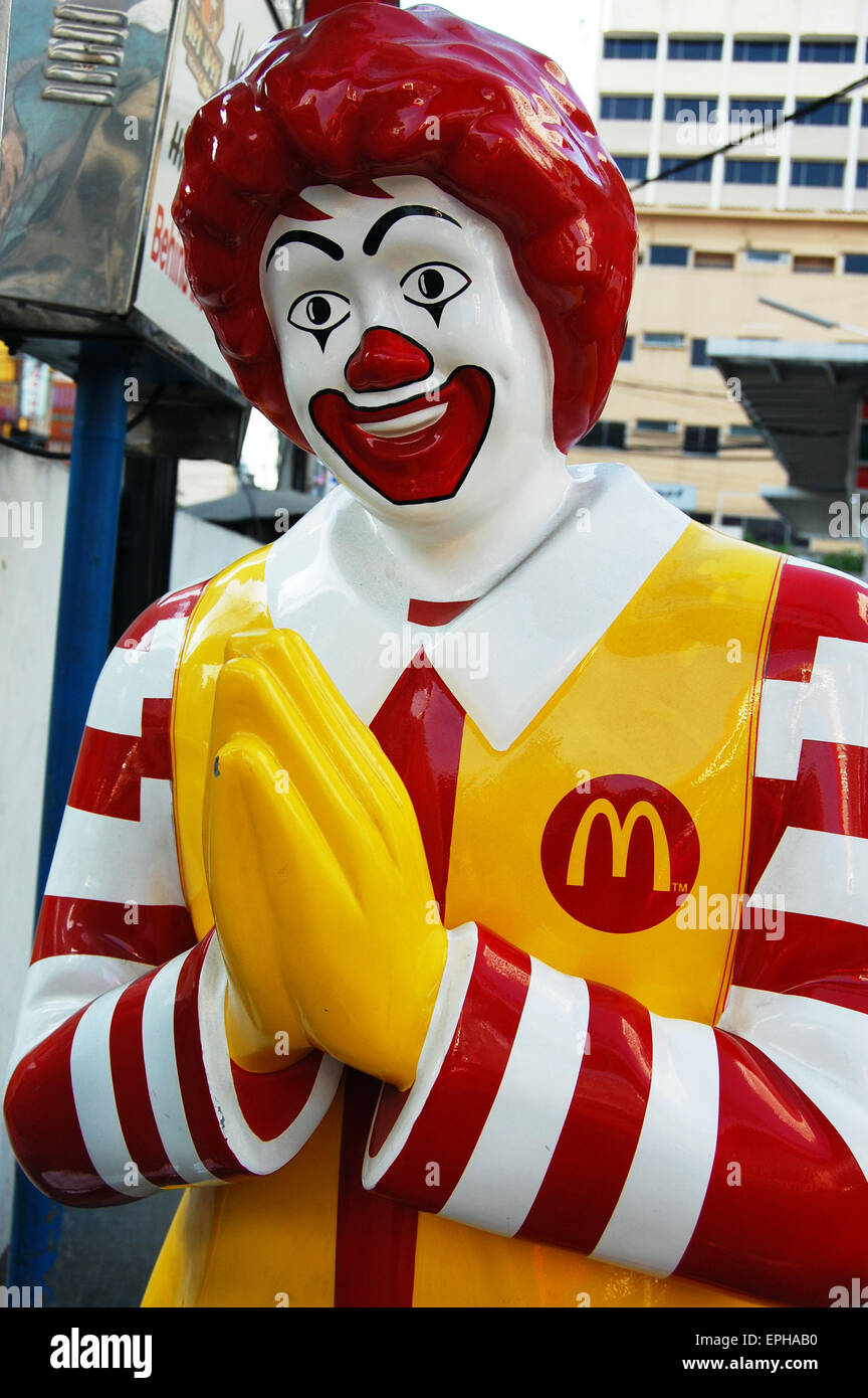 A statue of Ronald McDonald making a traditional wai greeting gesture in Bangkok Thailand Stock Photo