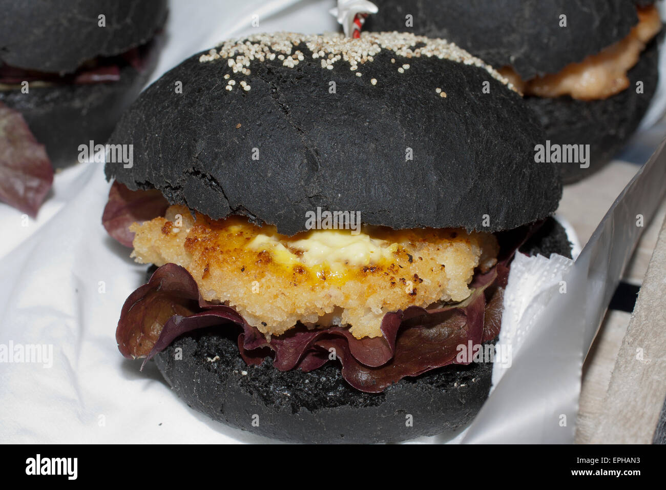 black fishburger, panino al nero di seppia con cotoletta di nasello - italian streetfood and seafood Stock Photo