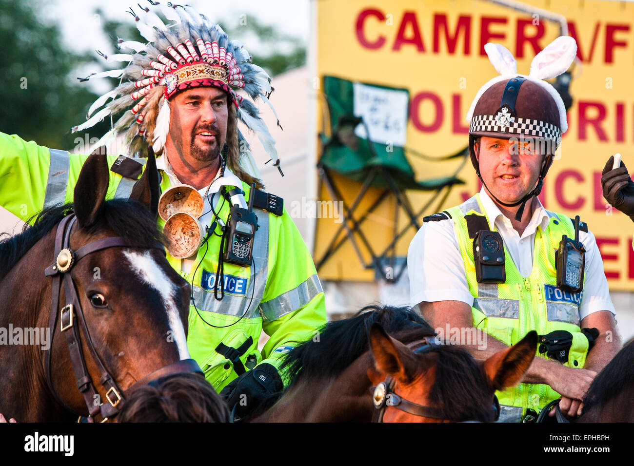 Horse mounted police get into the family party atmosphere by dressing up at Glastonbury Festival/ 'Glasto' held on working farm, Worthy Farm, near village of Pilton. Glastonbury Festival. Somerset, England. June. Stock Photo