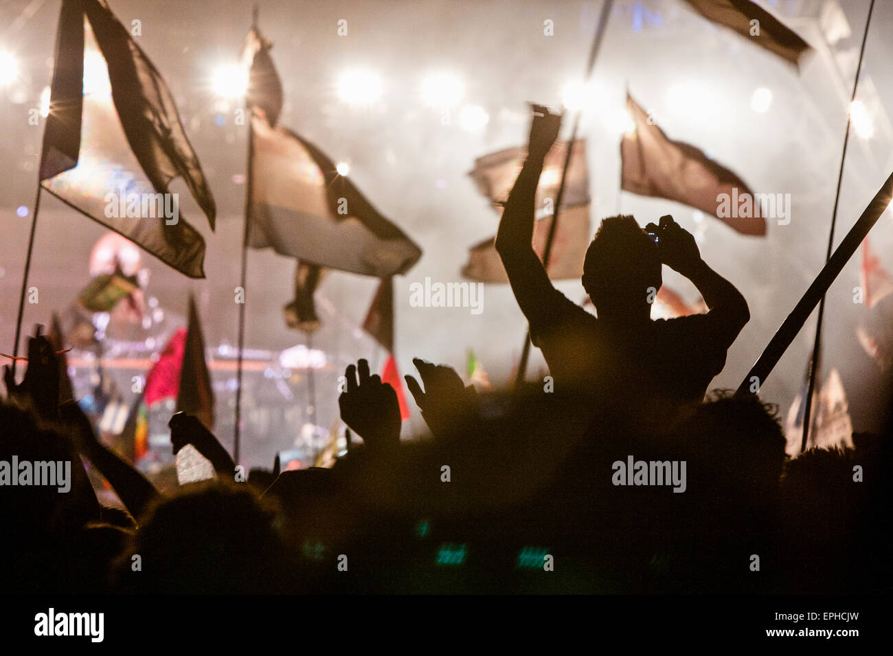 Flags and crowd at Pyramid Stage during headlining performance at Glastonbury Festival/ "Glasto" held on working farm, Worthy Fa Stock Photo