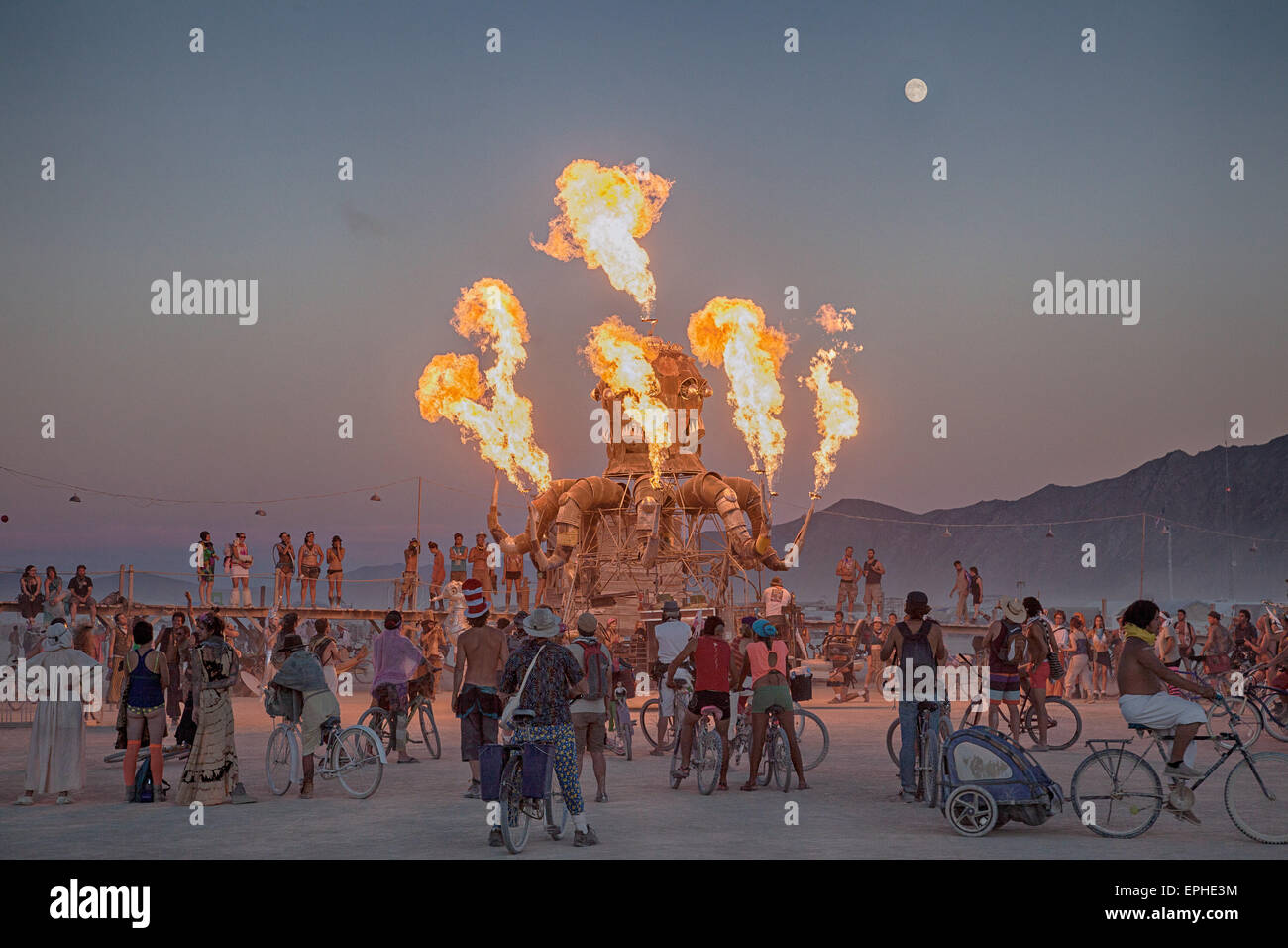 An art installation shoots flames in the desert during the annual Burning Man festival in the desert August 30, 2014 in Black Rock City, Nevada. Stock Photo