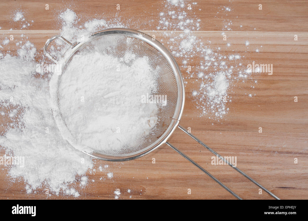 Sieve and flour on wooden surface. Baking concept Stock Photo Alamy