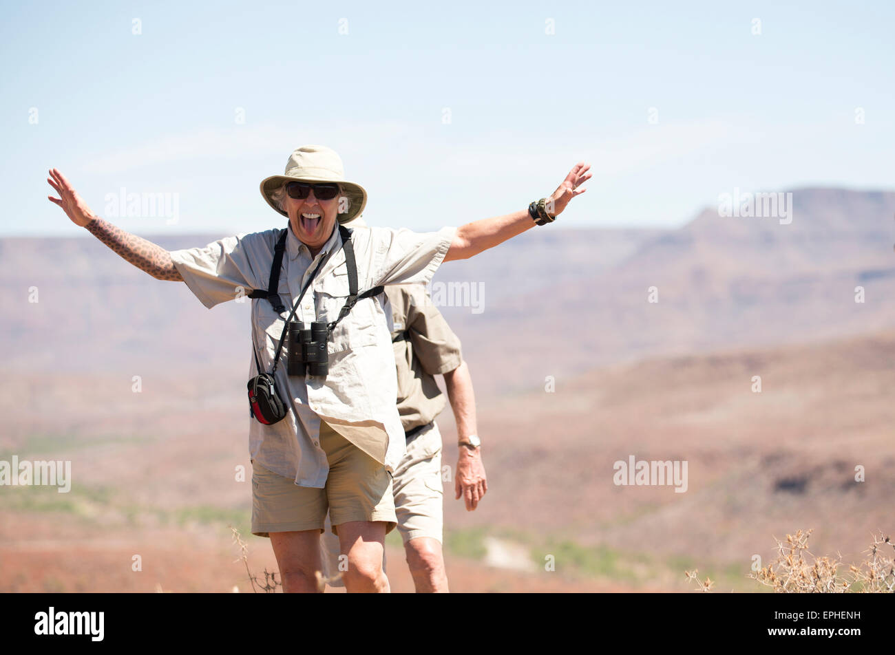 Africa, Namibia. Day trip tracking the Desert Black Rhinoceros. Woman making funny face Stock Photo