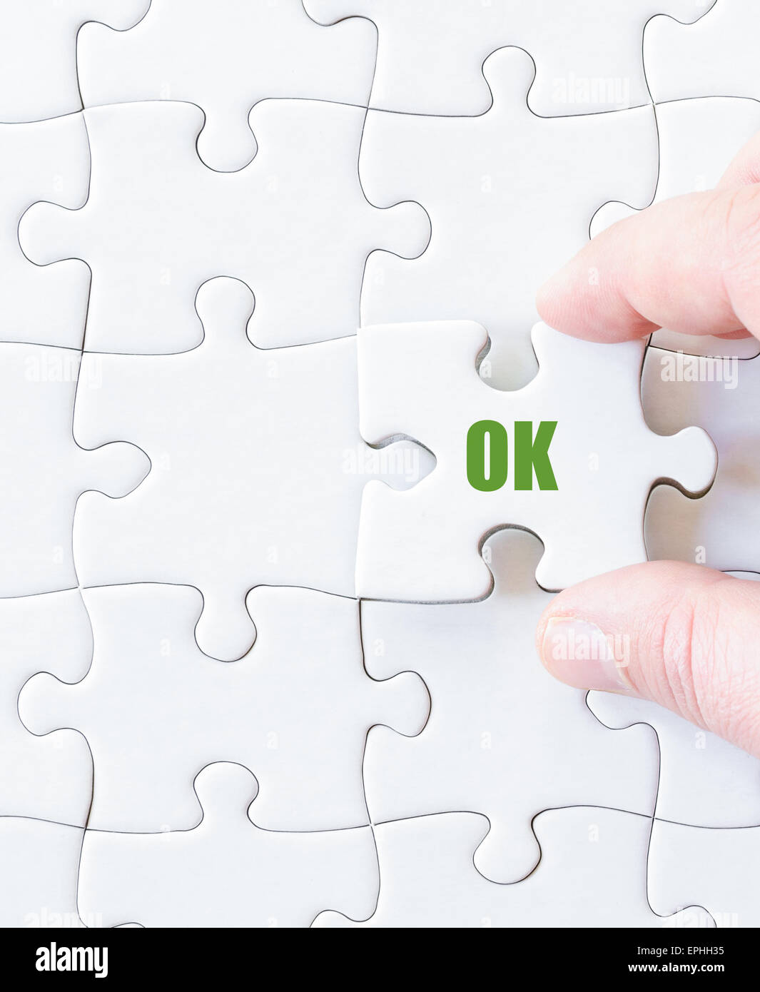 Missing jigsaw puzzle piece with word  OK. Business concept image for completing the puzzle. Stock Photo