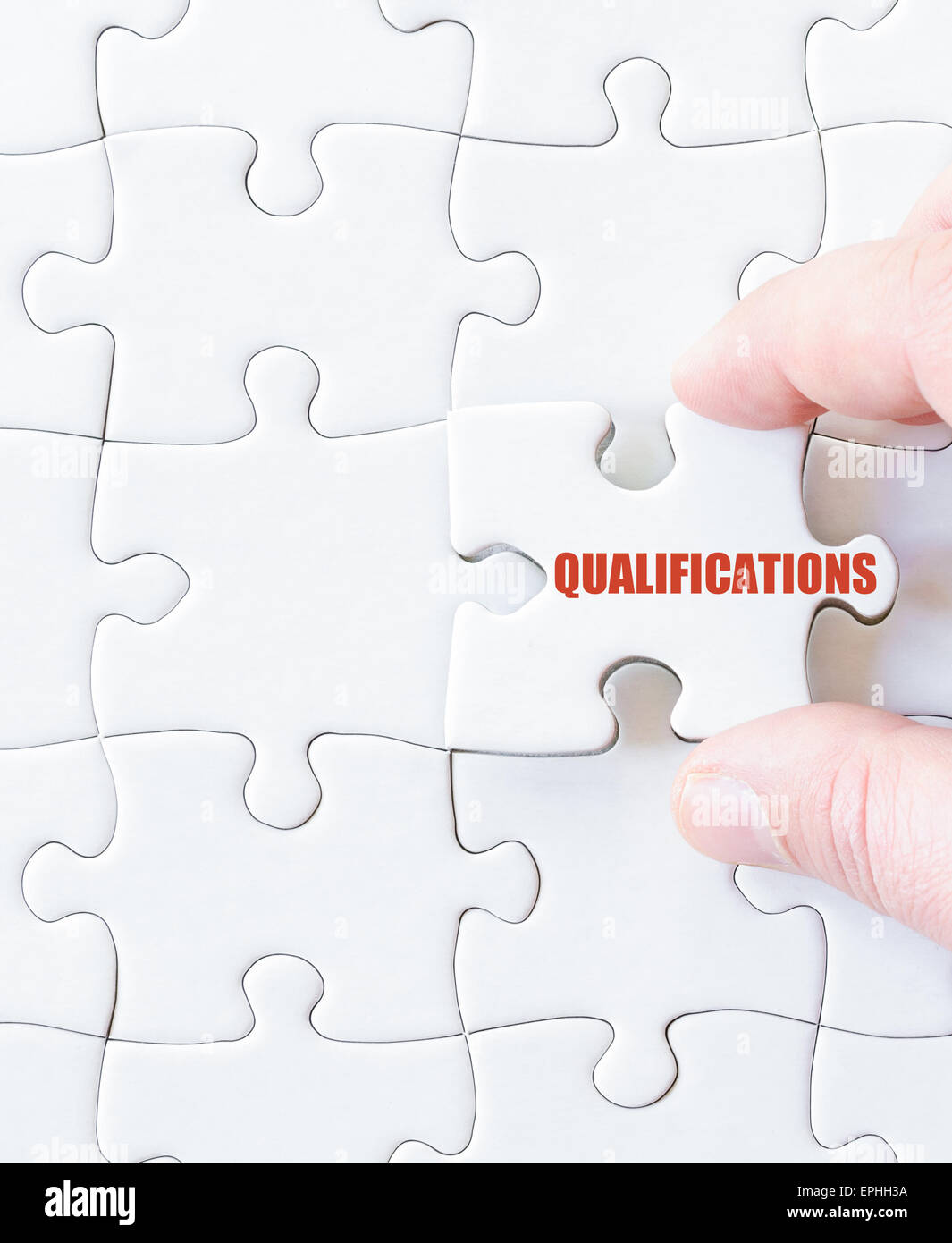 Missing jigsaw puzzle piece with word  QUALIFICATIONS. Business concept image for completing the puzzle. Stock Photo