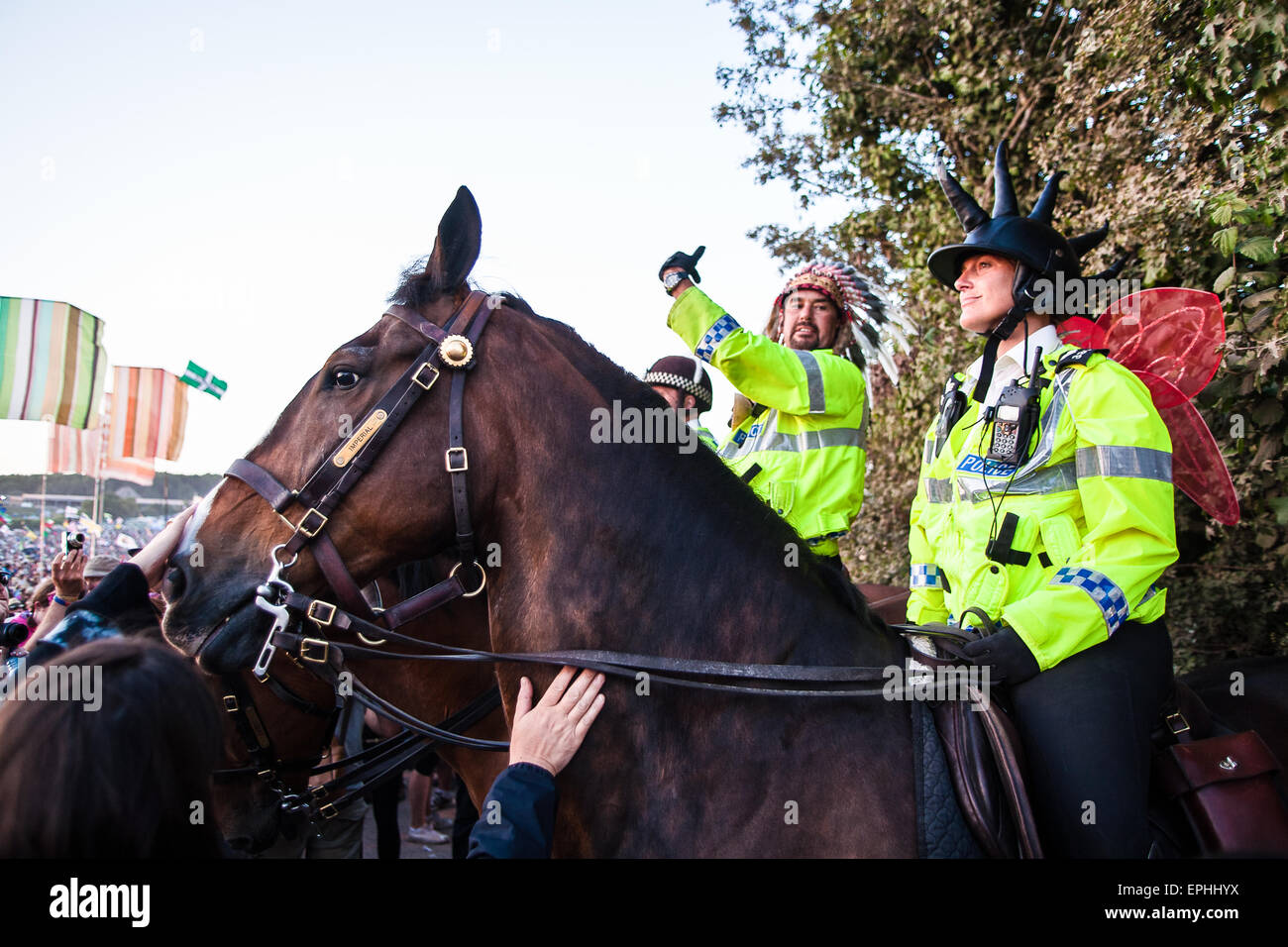 Horse mounted police get into the family party atmosphere by dressing up at Glastonbury Festival/ 'Glasto' held on working farm, Stock Photo