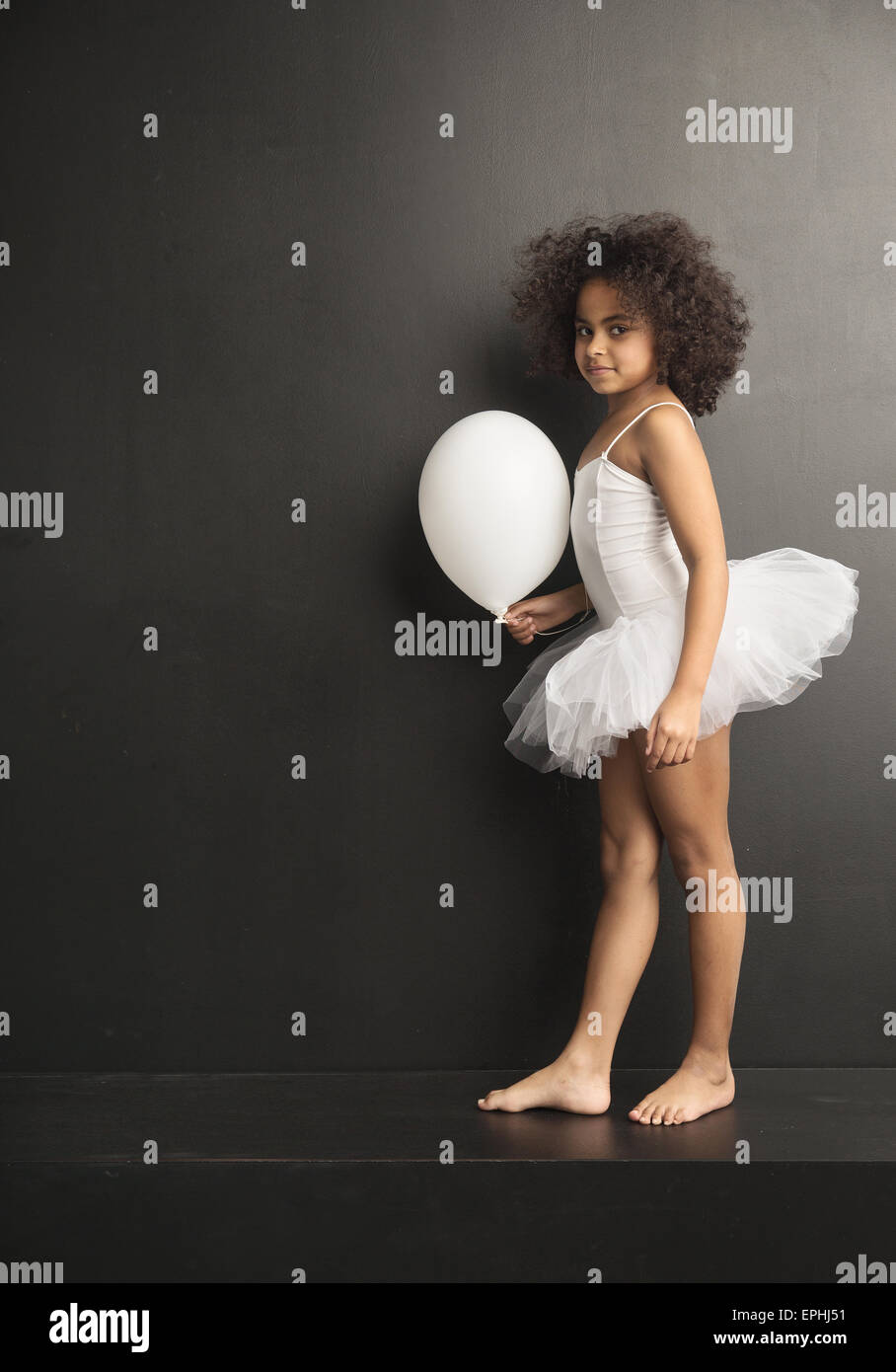 Conceptual picture of a little ballet dancer with a white balloon Stock Photo